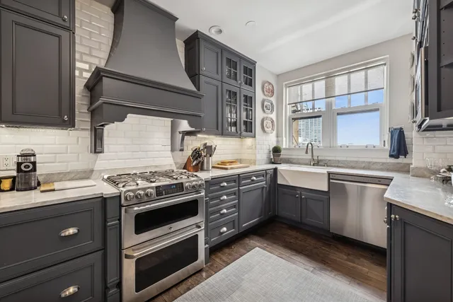 a kitchen with stainless steel appliances granite countertop a sink stove and oven