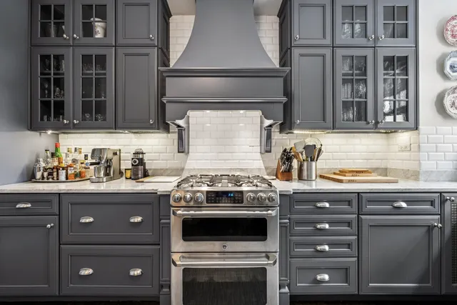 a kitchen with granite countertop a stove and a sink