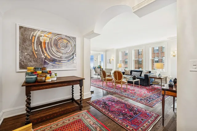 a living room with furniture a rug and a window