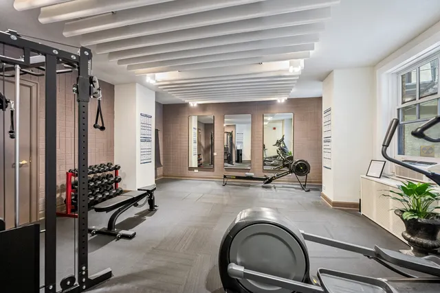 an aerial view of ocean and residential houses with outdoor space