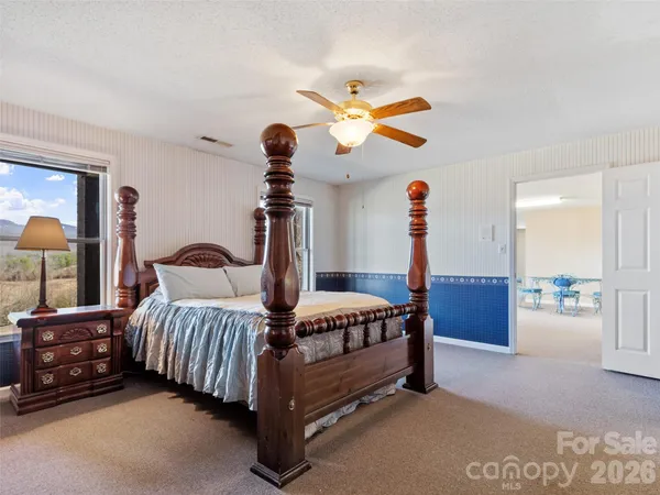 a bedroom with bed and a chandelier