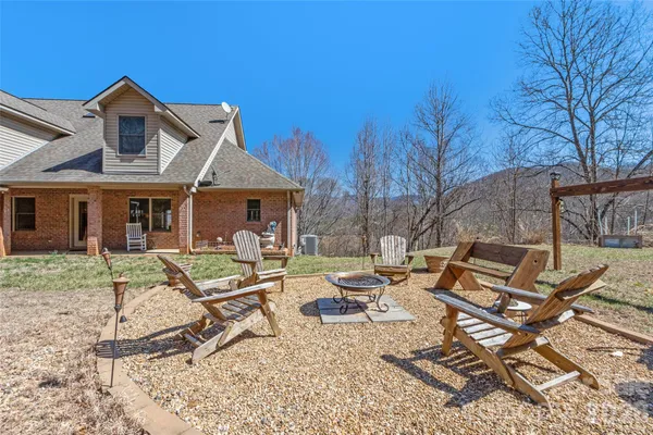 a view of a house with backyard sitting area and porch