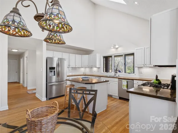 a kitchen with stainless steel appliances granite countertop a refrigerator and a stove top oven