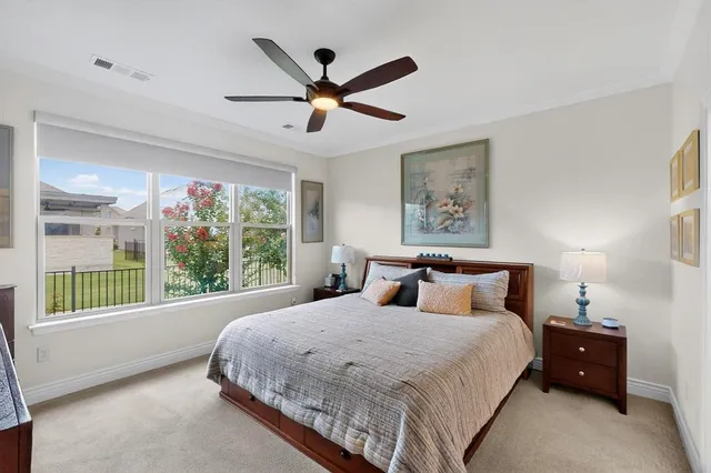 a bedroom with a large bed and a large window
