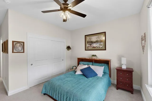 a bedroom with a bed and a painting on the wall