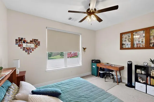 a bedroom with furniture and a window