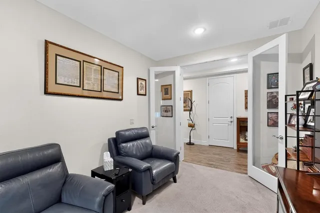 a living room with furniture and a book shelf