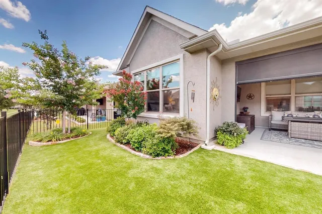 a view of an house with backyard and patio