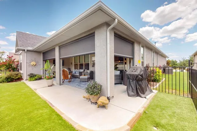 a view of a house with backyard outdoor seating area and furniture