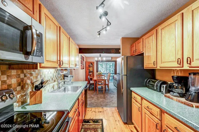 a bathroom with a granite countertop toilet sink and mirror