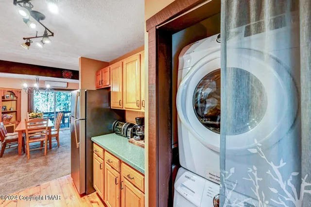 a bathroom with a granite countertop toilet sink and mirror