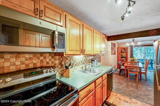 a bathroom with a granite countertop sink a mirror and a shower