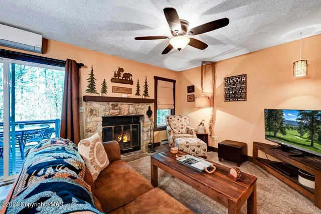 a living room with furniture a flat screen tv and a fireplace