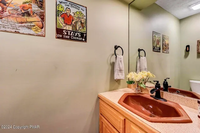 a roof deck with table and chairs and wooden floor