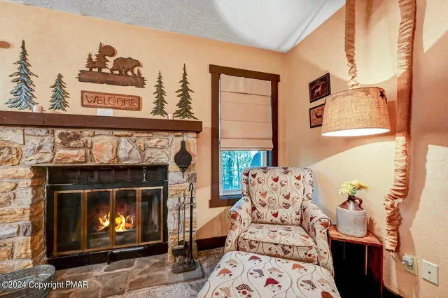 a living room with fireplace furniture and a chandelier
