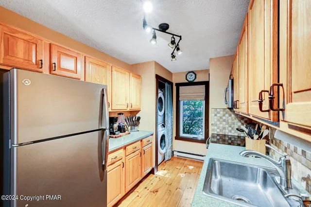 a living room with furniture a fireplace and a large window
