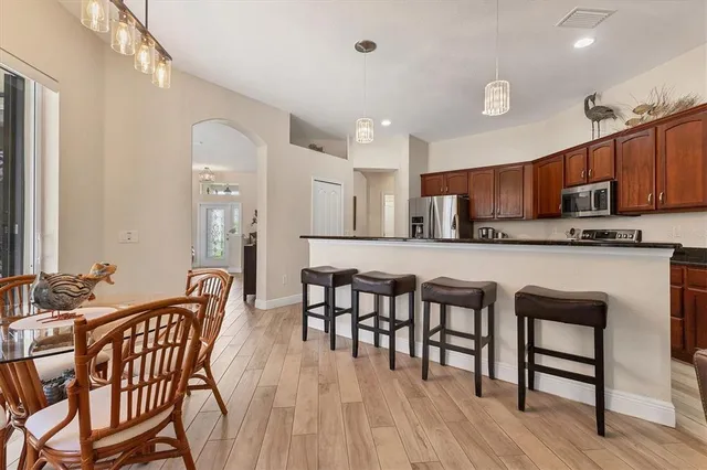 a large kitchen with stainless steel appliances granite countertop a stove a sink and a microwave