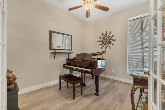 a bedroom with a bed a chair and piano