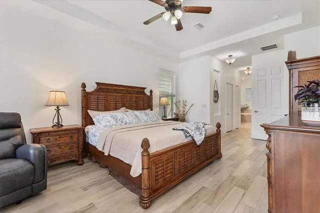 a bedroom with a bed and a chandelier