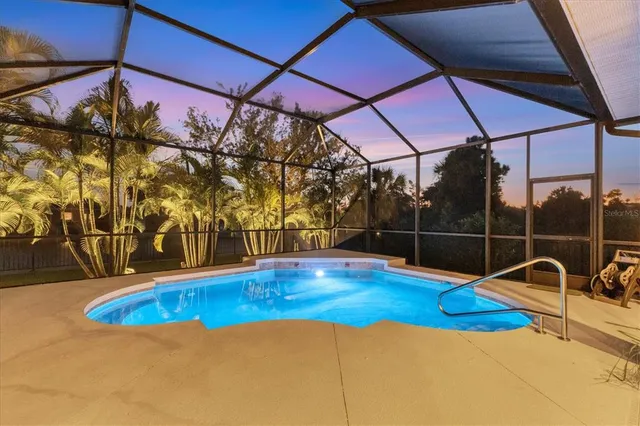 an aerial view of a house with swimming pool outdoor seating and yard
