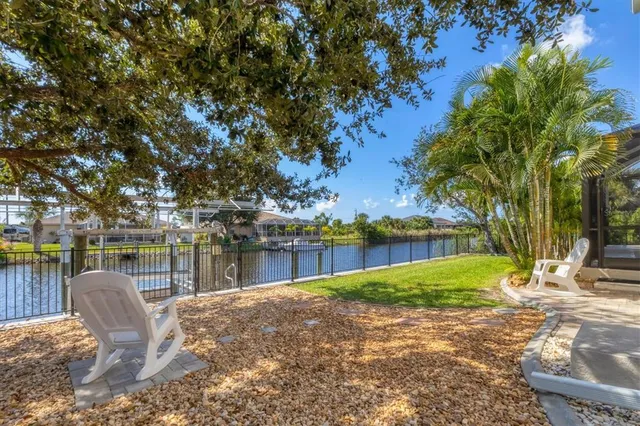 an aerial view of a house with a garden and lake view