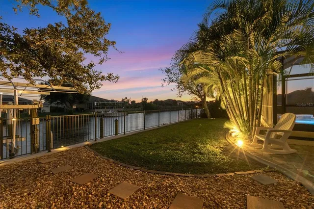 an aerial view of a golf course with a lake view