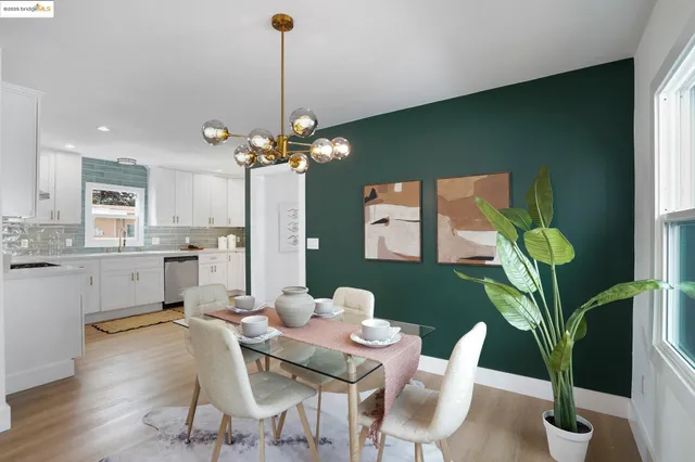 a dining room with furniture and a potted plant
