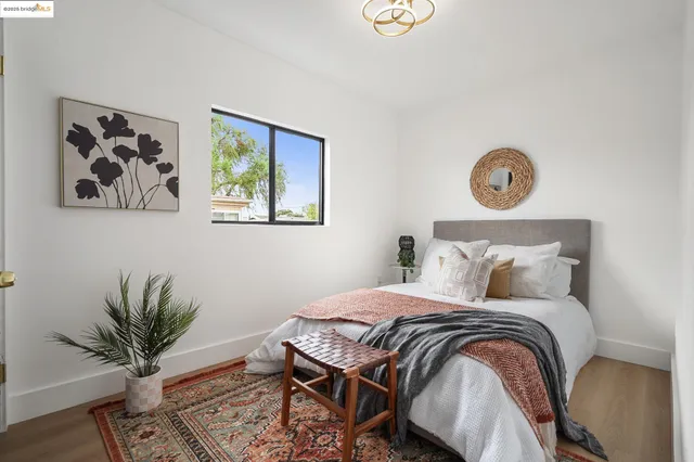 a bedroom with a large bed and a potted plant