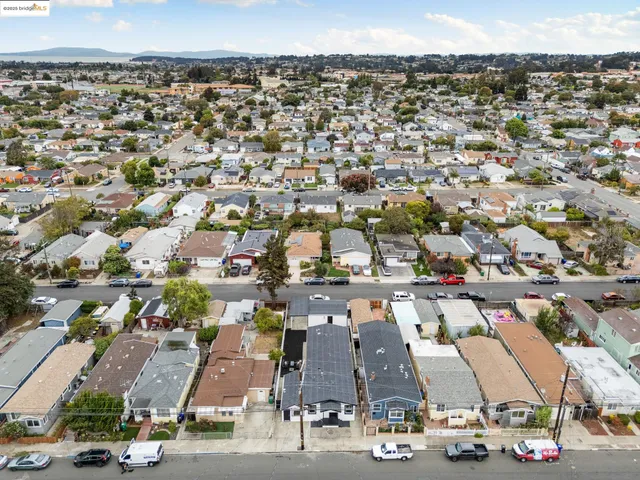 an aerial view of residential houses with outdoor space
