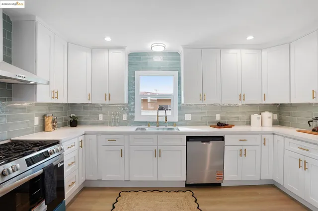 a kitchen with a sink stove and cabinets