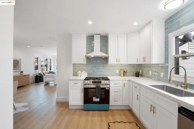 a kitchen with a stove a sink and a refrigerator