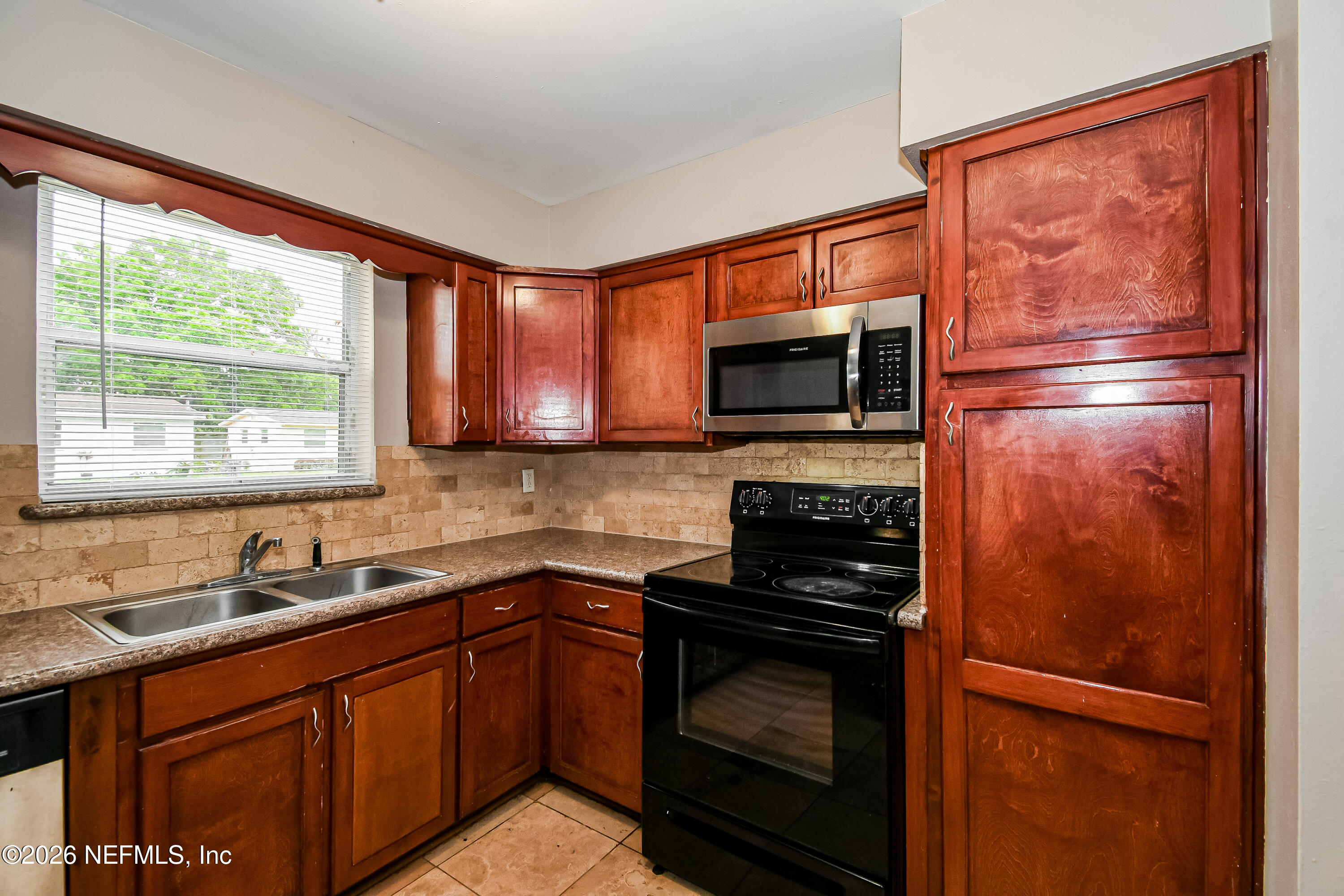 7227 Stonehurst Road North Jacksonville, FL 32277 - Photo 7 of 16 a kitchen with a refrigerator stove and sink