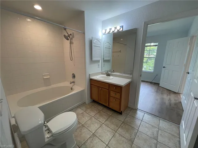 a bathroom with a tub toilet sink and mirror