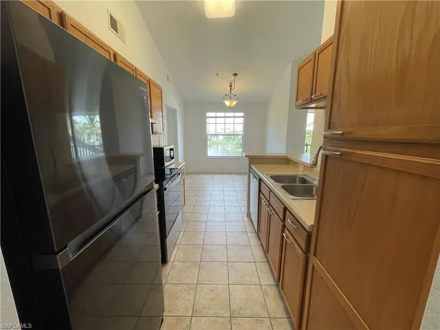 a kitchen with granite countertop stainless steel appliances a counter top space and cabinets