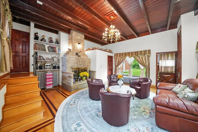 a living room filled with furniture windows and a chandelier