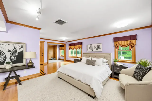 a bedroom with a bed and glass windows