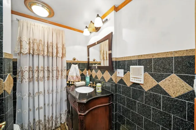 a bathroom with a sink vanity and mirror