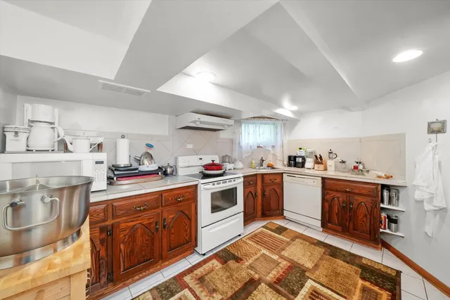 a kitchen with a sink stove top oven and cabinets