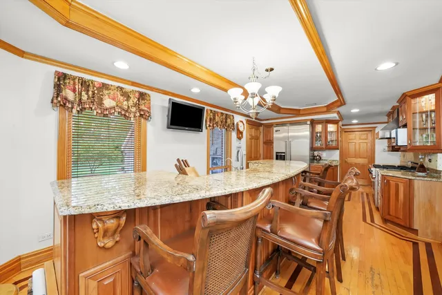 a very nice looking dining room with a large kitchen island furniture and a chandelier