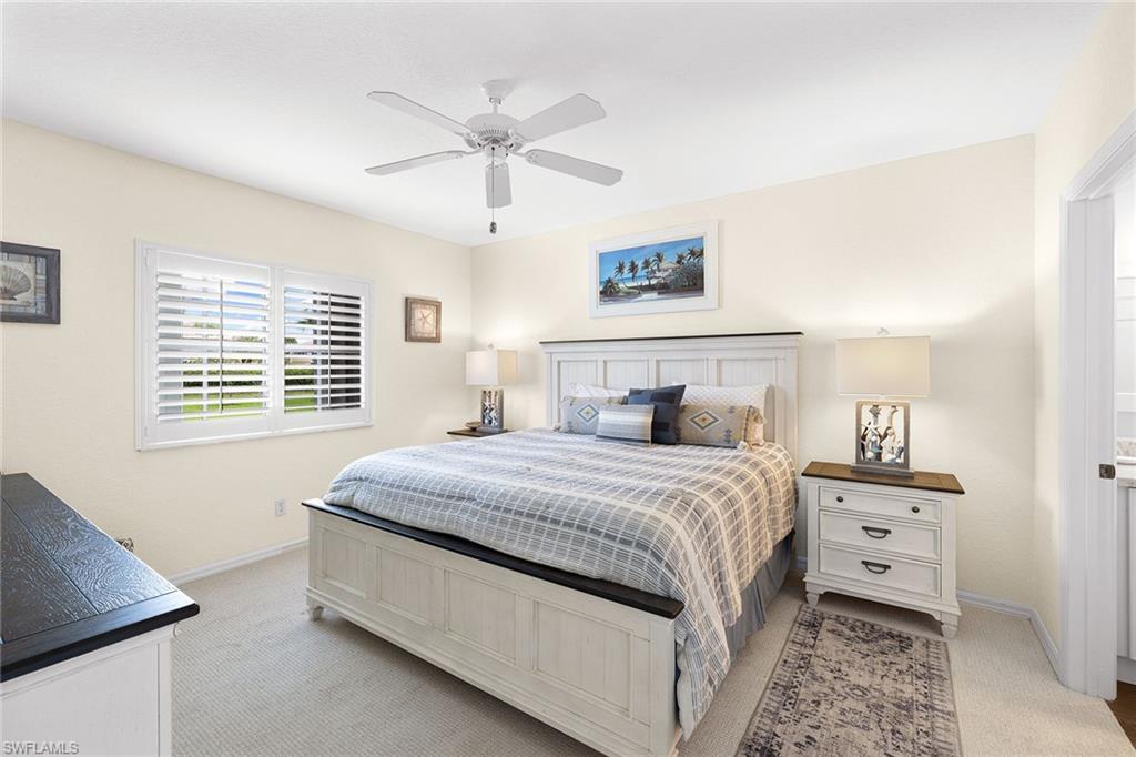 9022 Michael Circle, Unit 3 Naples, FL 34113 - Photo 18 of 25 a bedroom with a bed and a window