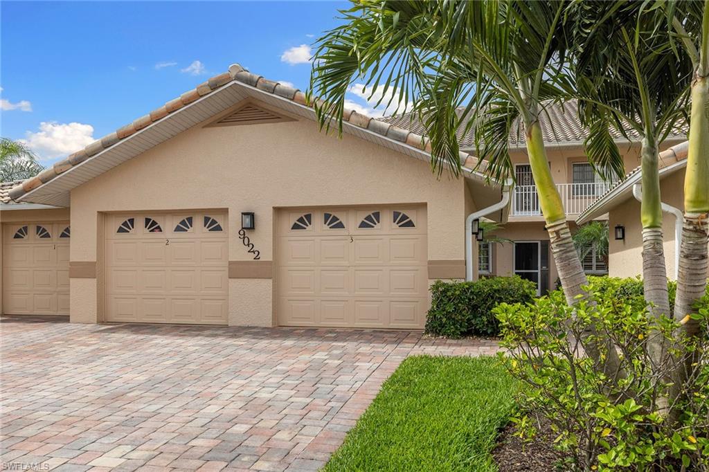 9022 Michael Circle, Unit 3 Naples, FL 34113 - Photo 2 of 25 a front view of a house with a yard
