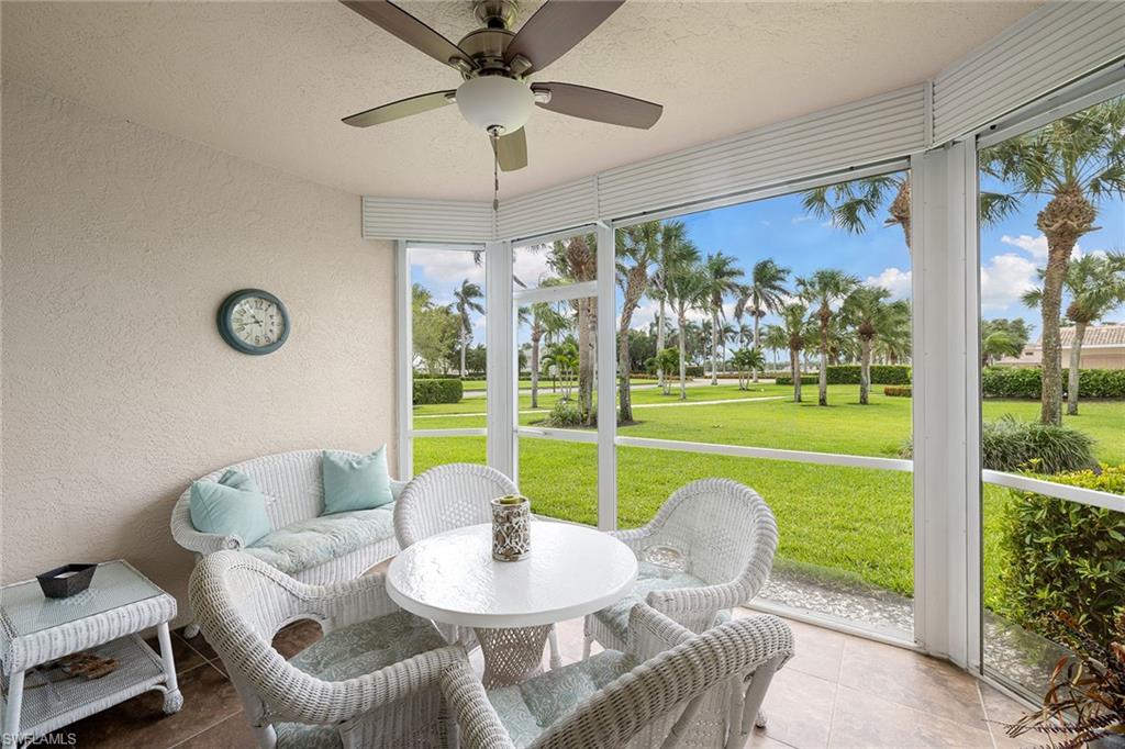 9022 Michael Circle, Unit 3 Naples, FL 34113 - Photo 21 of 25 a living room with patio furniture and a large window