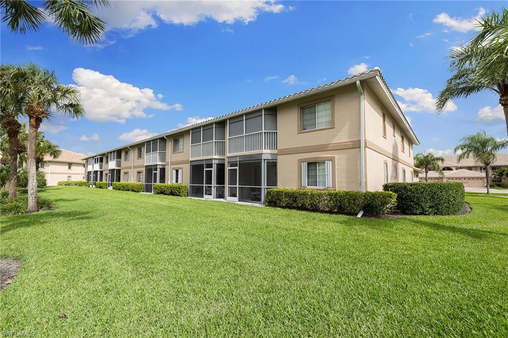 9022 Michael Circle, Unit 3 Naples, FL 34113 - Photo 22 of 25 a view of a house with a yard