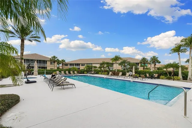 a view of a patio with swimming pool and furniture