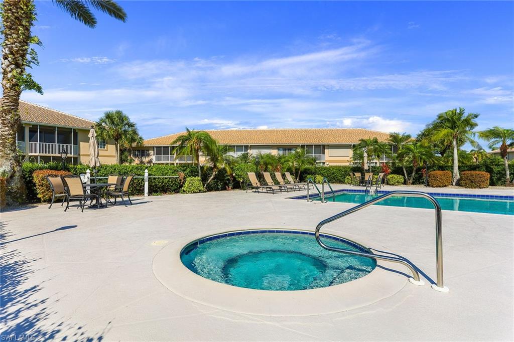 9022 Michael Circle, Unit 3 Naples, FL 34113 - Photo 25 of 25 a view of a swimming pool with a patio