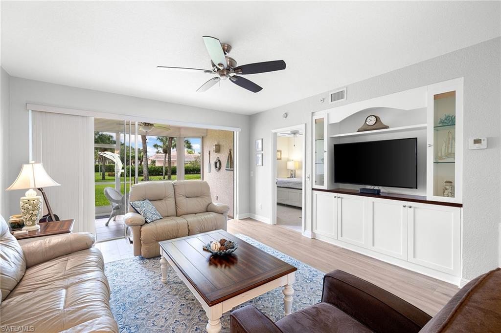 9022 Michael Circle, Unit 3 Naples, FL 34113 - Photo 6 of 25 a living room with furniture and a flat screen tv