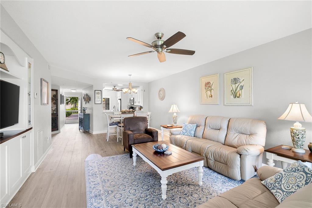 9022 Michael Circle, Unit 3 Naples, FL 34113 - Photo 8 of 25 a living room with furniture and a flat screen tv