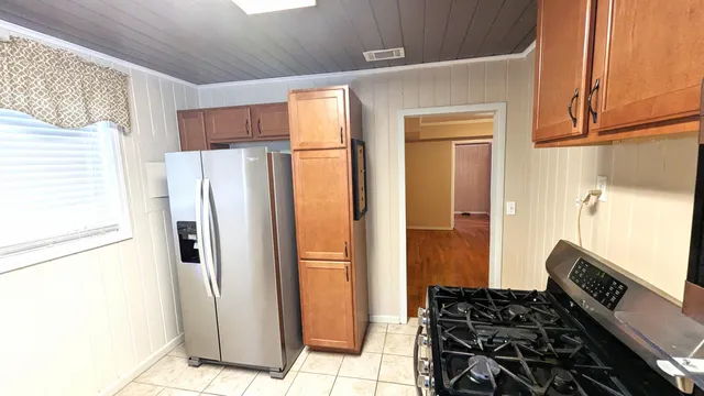a kitchen with stainless steel appliances granite countertop a refrigerator and a stove
