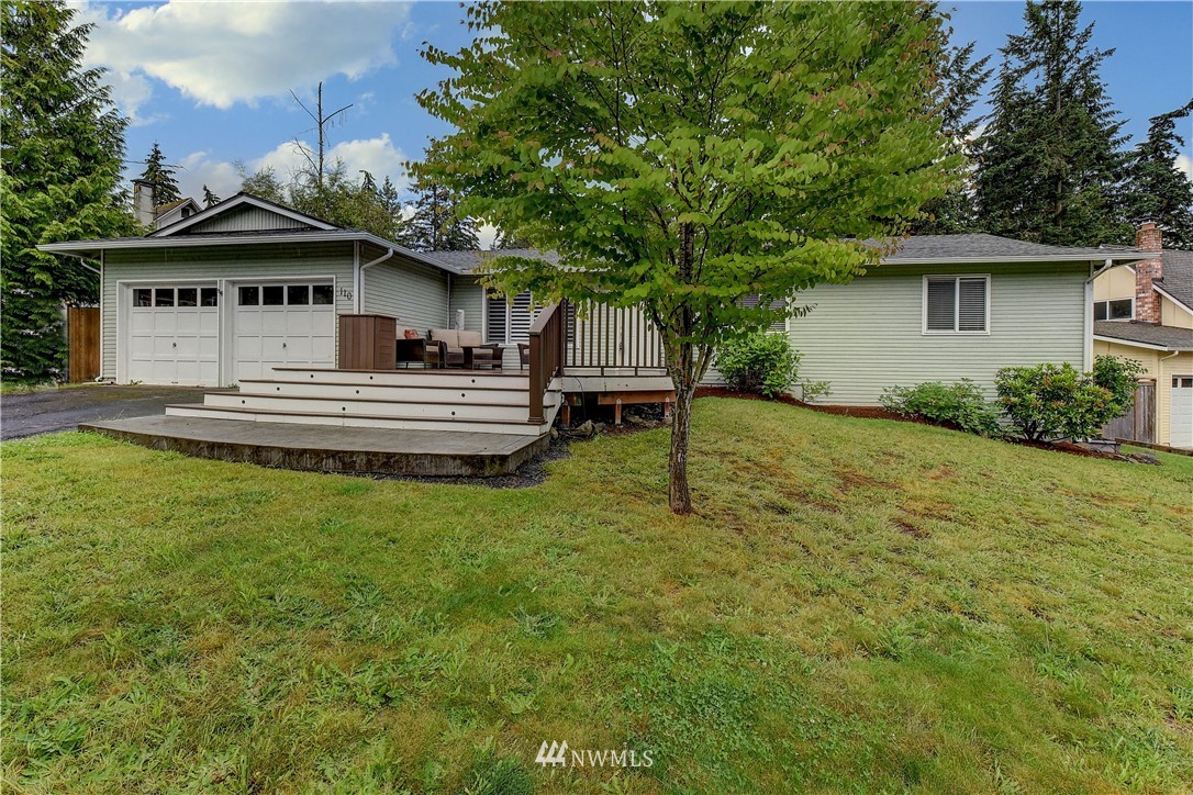 110 219th Place Southeast Bothell, WA 98021 - Photo 1 of 27 a front view of a house with a garden and yard