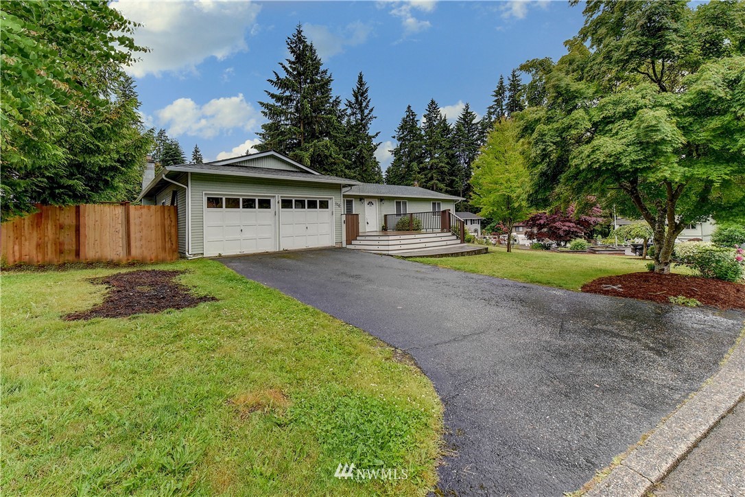 110 219th Place Southeast Bothell, WA 98021 - Photo 3 of 27 a view of a big house with a big yard and large trees